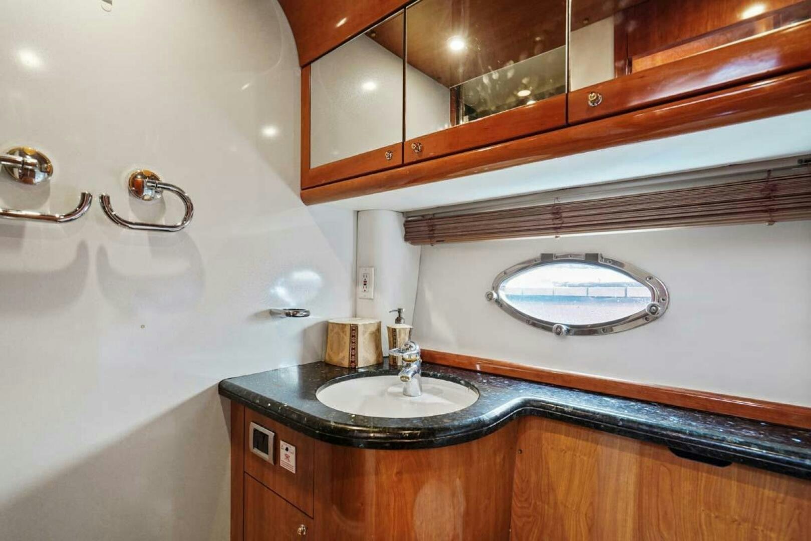 a bathroom with a sink and a mirror aboard OBSESSION Yacht for Sale