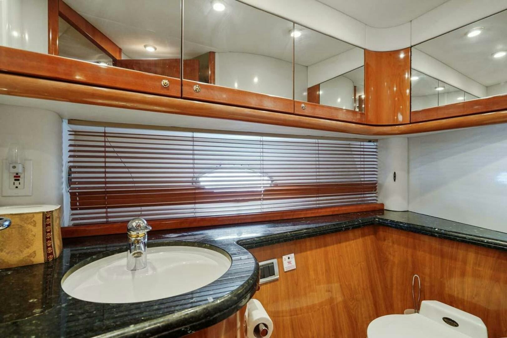 a bathroom with a sink and cabinets aboard OBSESSION Yacht for Sale