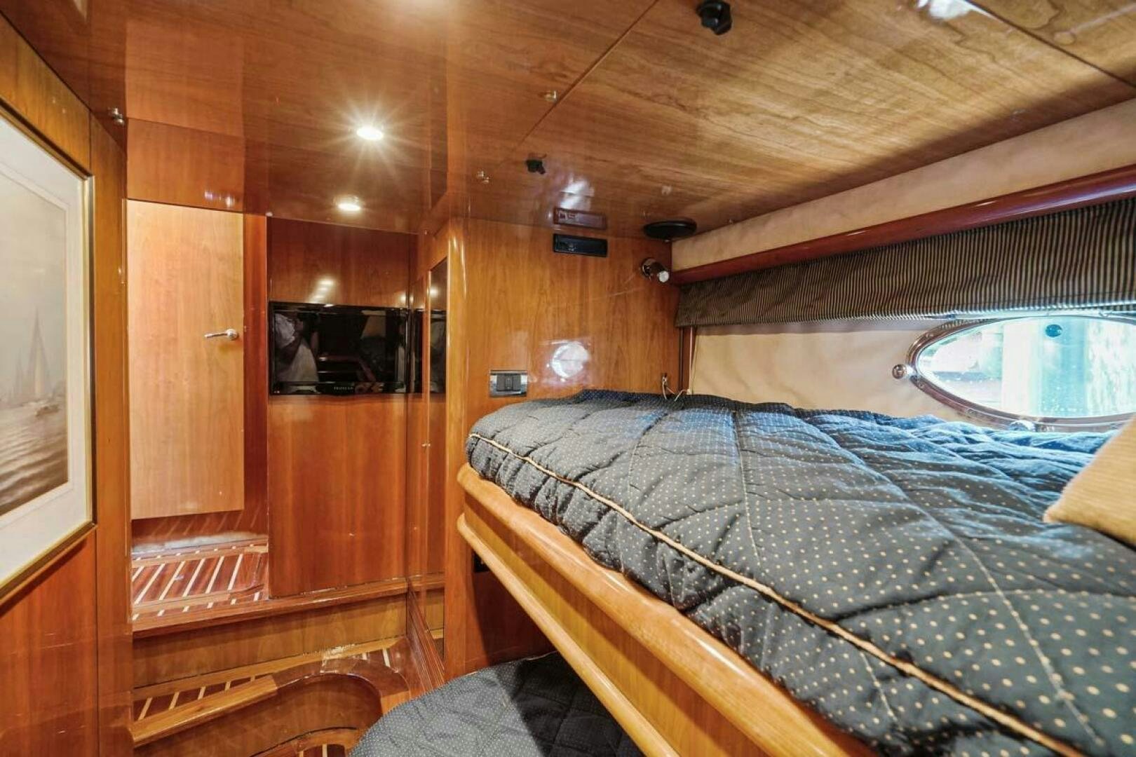 a cabin with a bed aboard OBSESSION Yacht for Sale