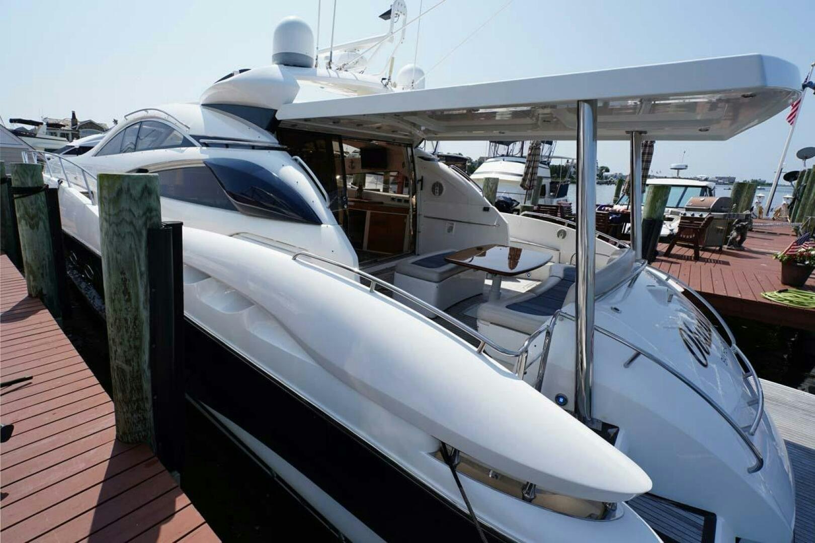 a boat docked at a pier aboard OBSESSION Yacht for Sale