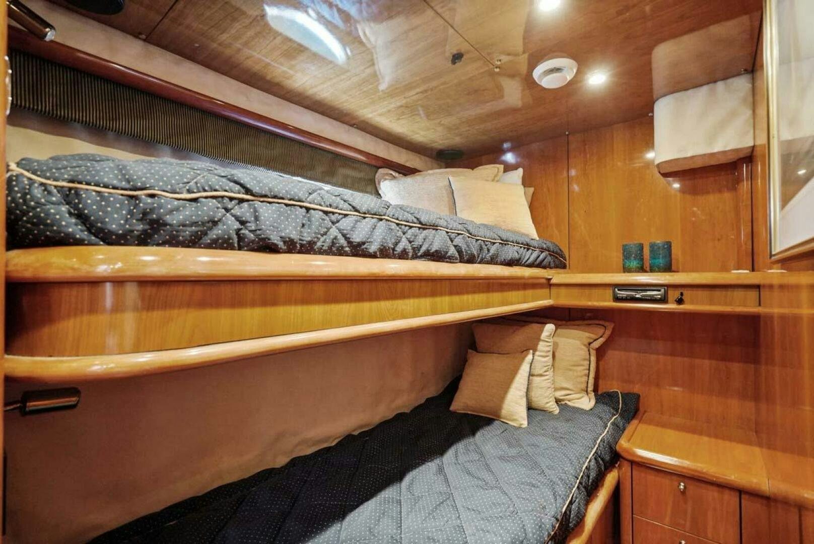a bed with a wooden headboard aboard OBSESSION Yacht for Sale