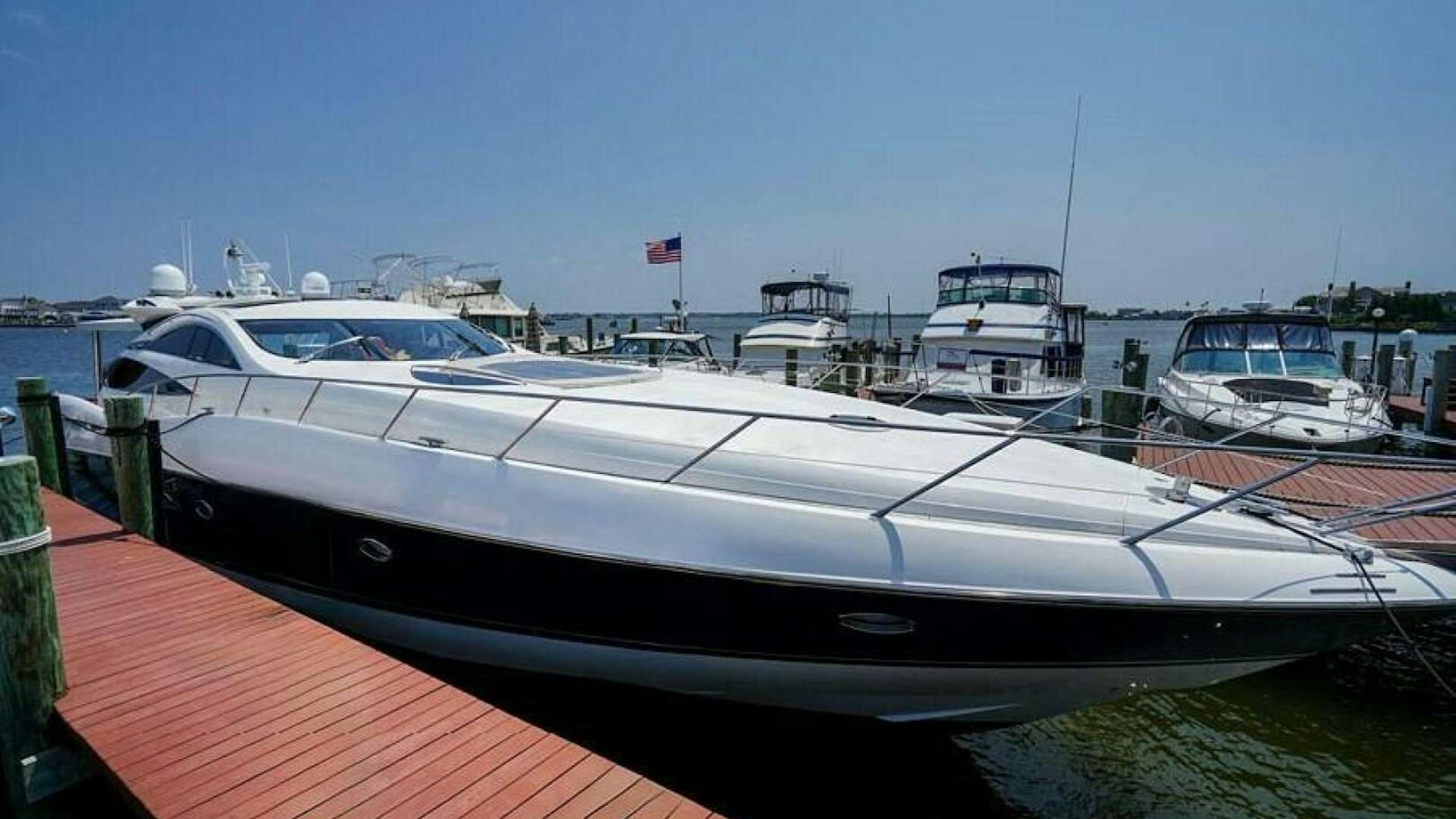 a boat docked at a pier aboard OBSESSION Yacht for Sale