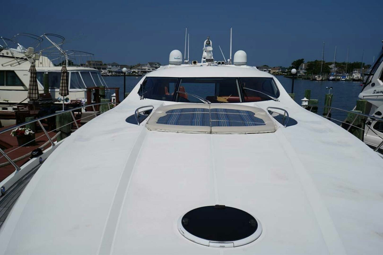 a white yacht in a harbor aboard OBSESSION Yacht for Sale