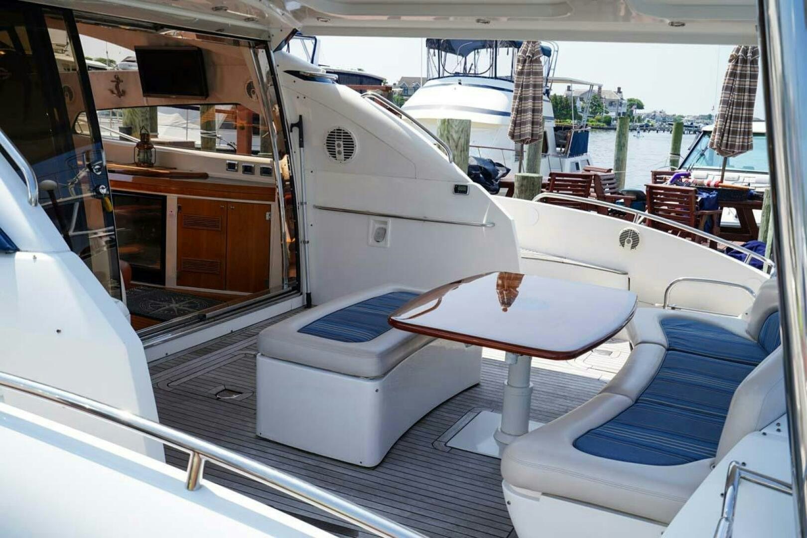 a boat with a table and chairs aboard OBSESSION Yacht for Sale