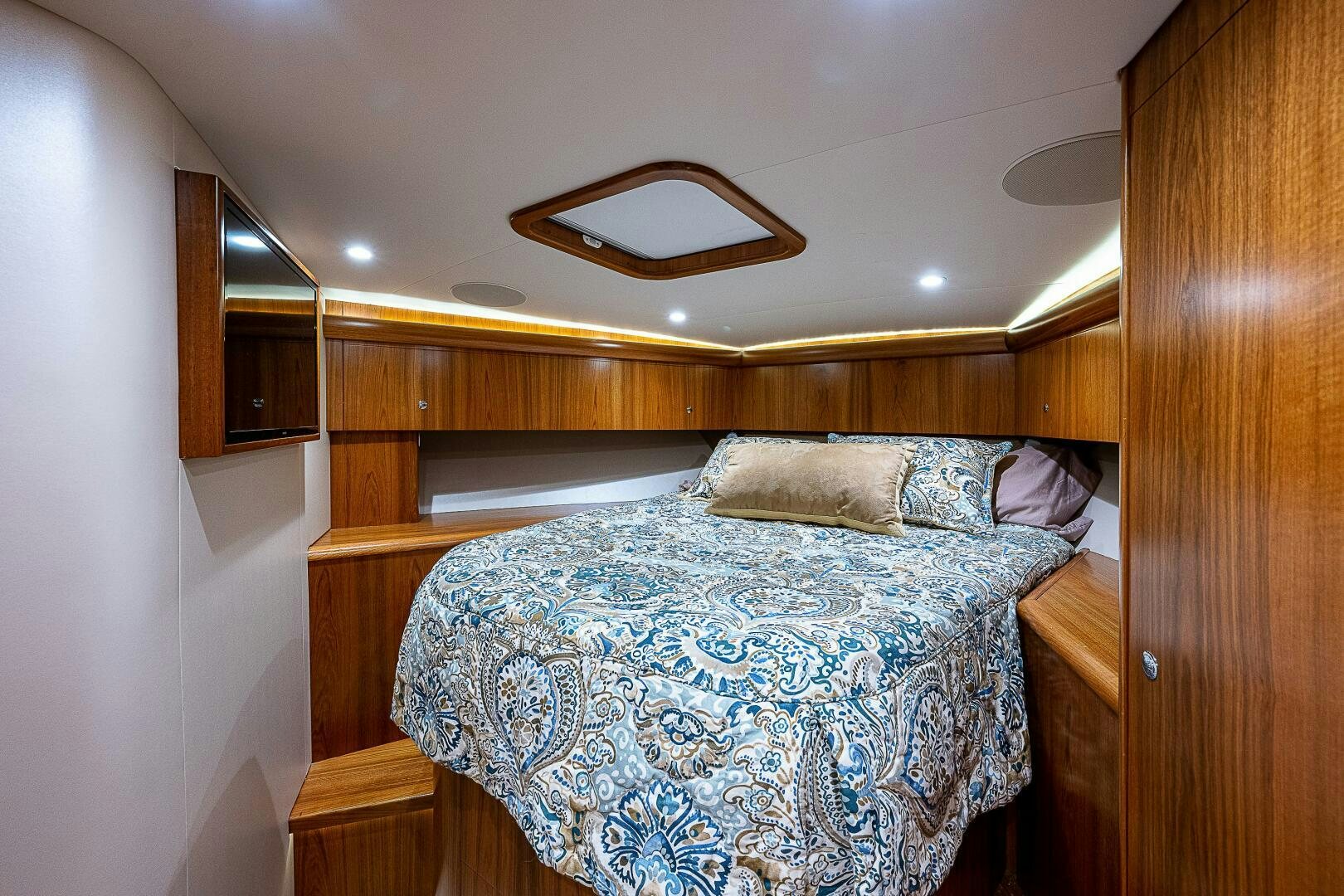 a bed with a blue comforter aboard MAXIMUS Yacht for Sale