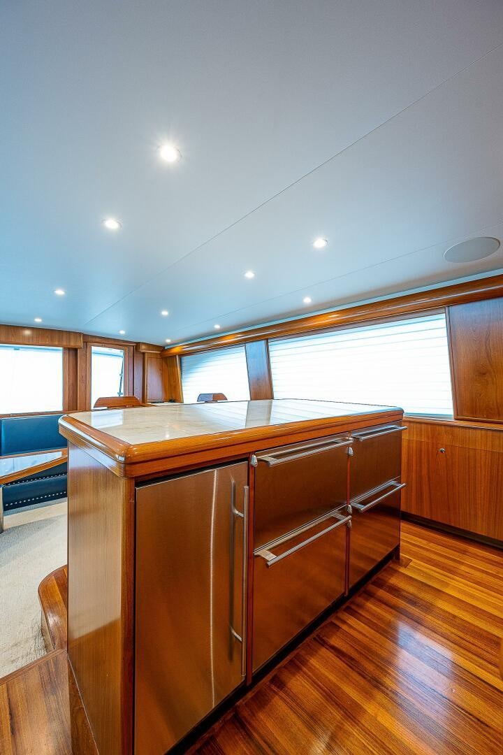 a kitchen with wooden cabinets aboard MAXIMUS Yacht for Sale