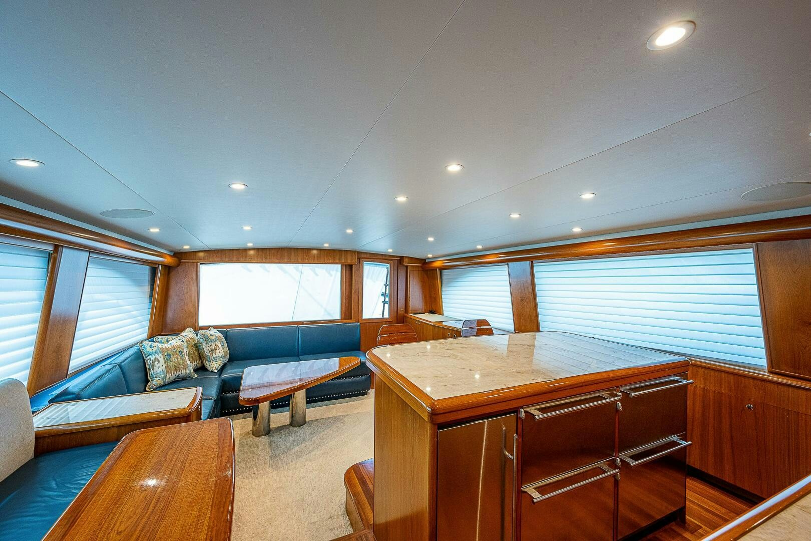 a large living room with a wood table and a couch aboard MAXIMUS Yacht for Sale