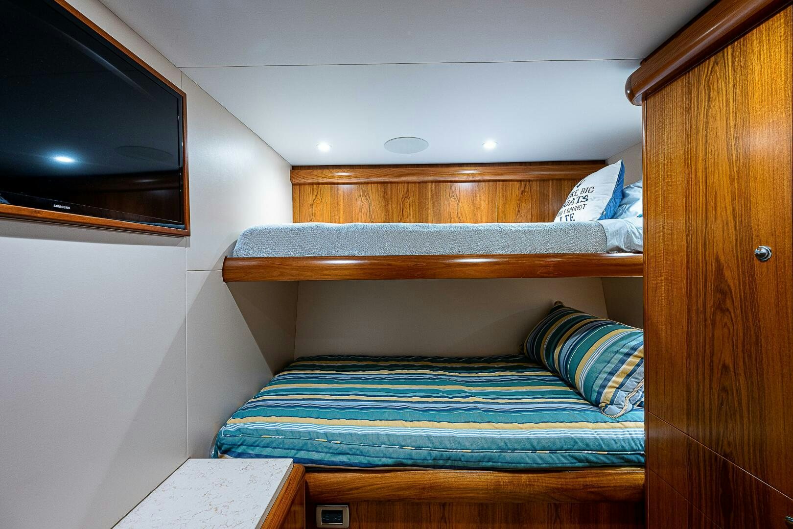 a bed with a television on the wall aboard MAXIMUS Yacht for Sale
