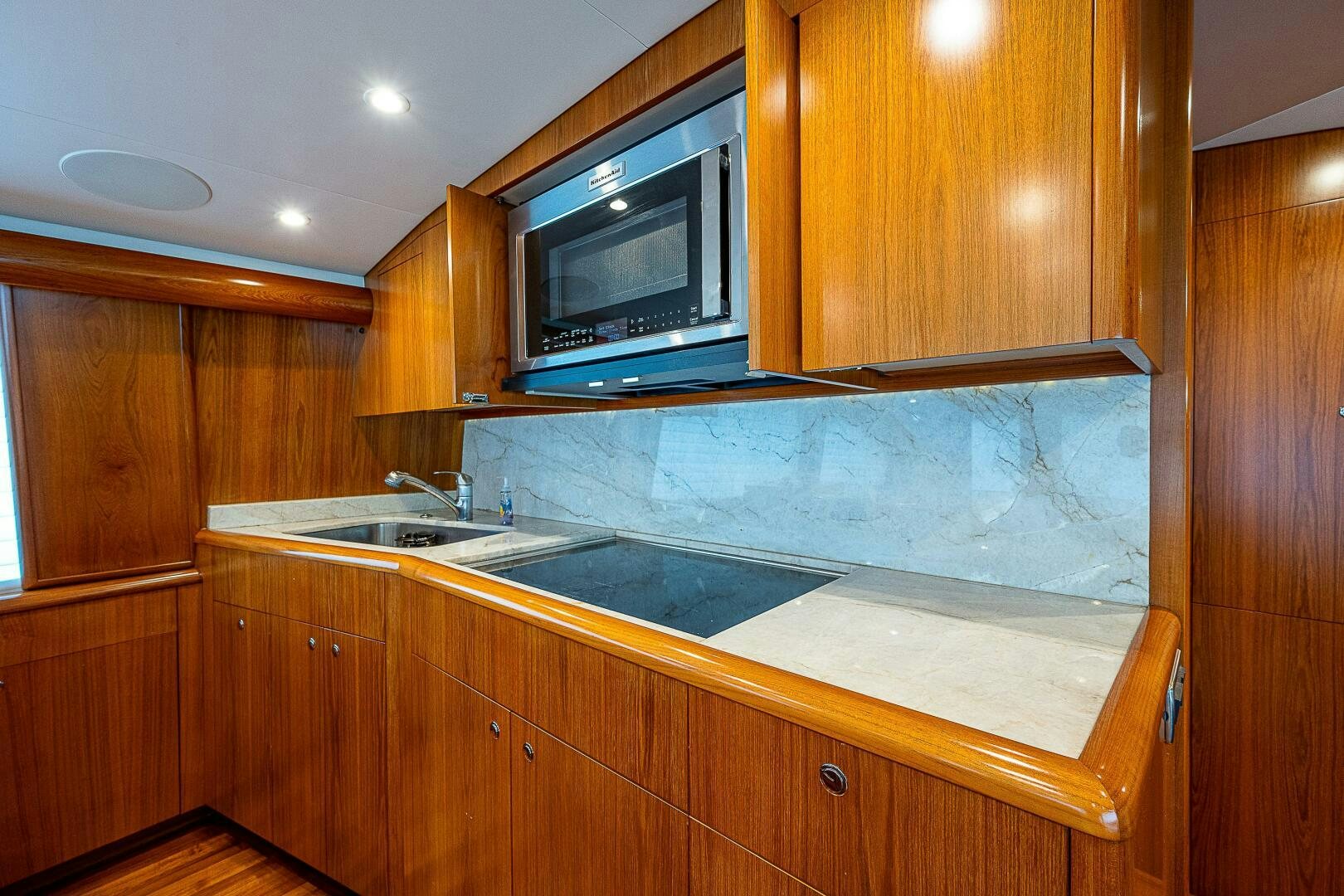 a kitchen with wooden cabinets aboard MAXIMUS Yacht for Sale
