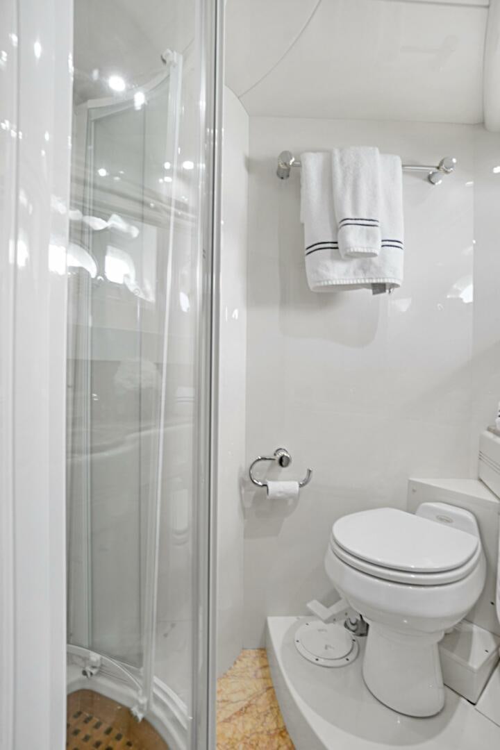 a bathroom with a glass shower door aboard SUN ADVENTURES Yacht for Sale