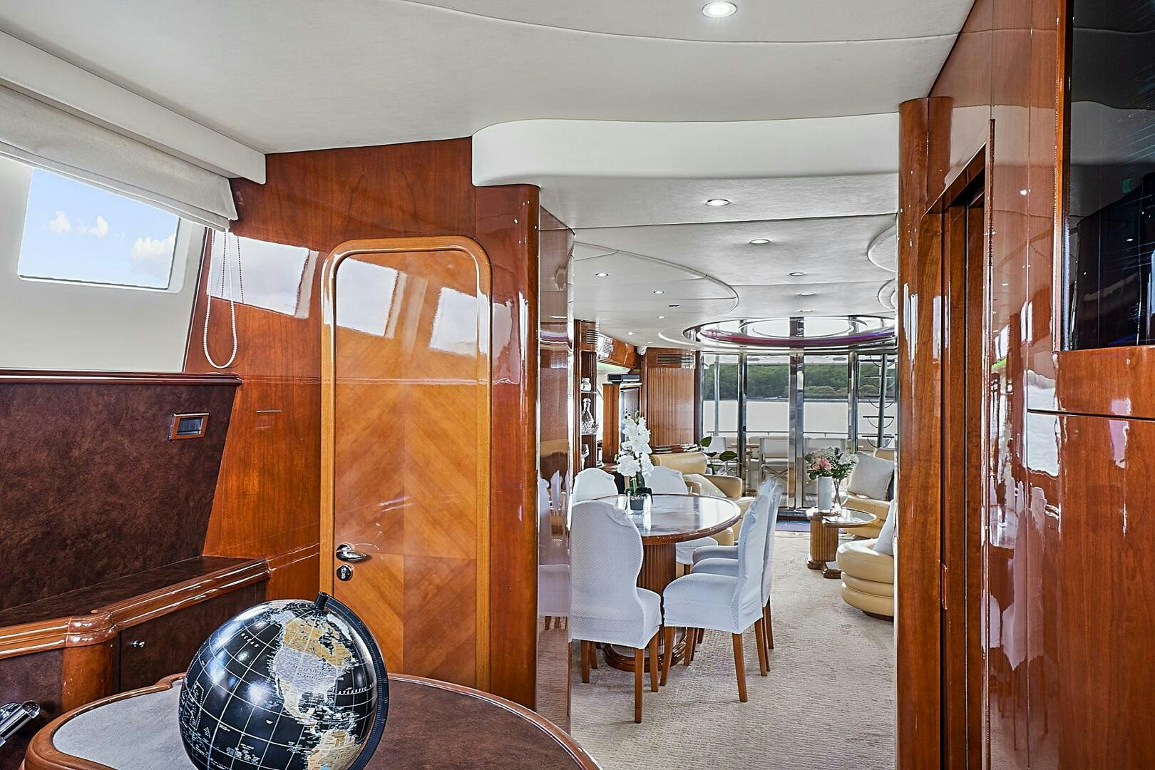 a room with a table chairs and a fan aboard SUN ADVENTURES Yacht for Sale
