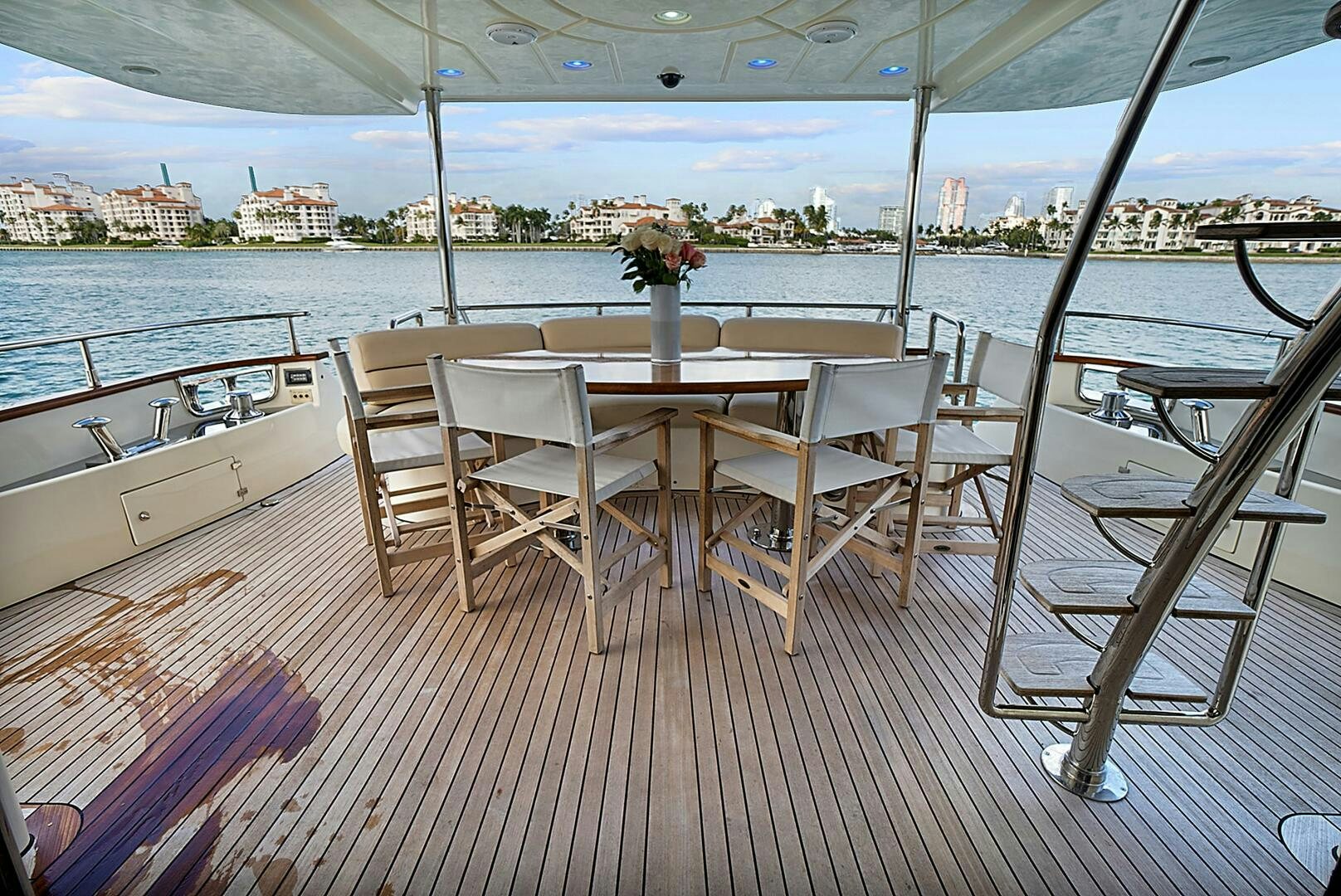 a table and chairs on a deck overlooking a body of water aboard SUN ADVENTURES Yacht for Sale