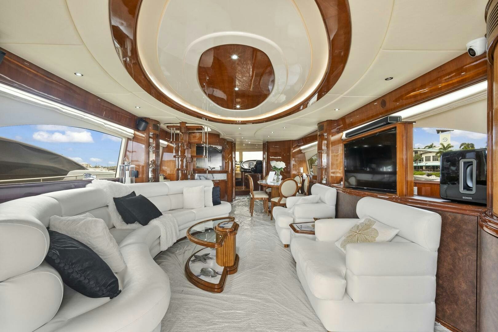 a large room with a large mirror above a white couch aboard SUN ADVENTURES Yacht for Sale