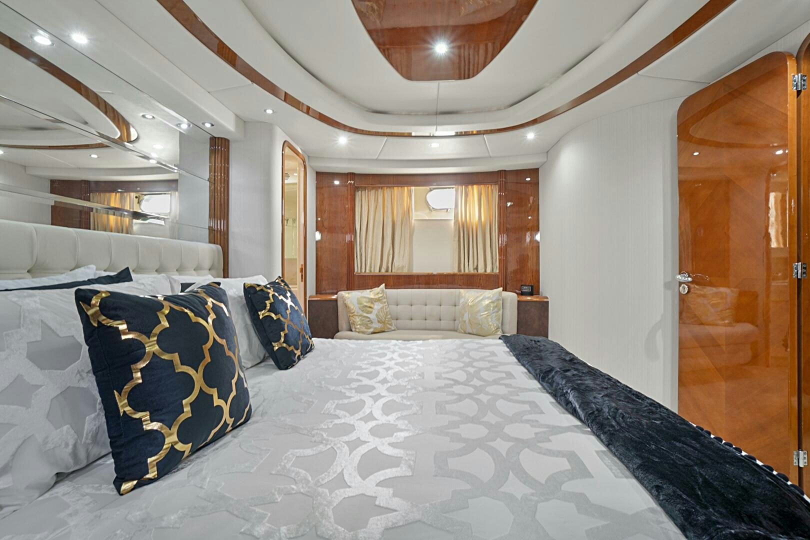 a large bed with blue and white sheets aboard SUN ADVENTURES Yacht for Sale
