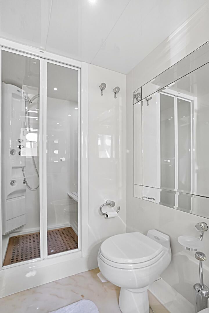 a bathroom with a glass shower aboard SUN ADVENTURES Yacht for Sale