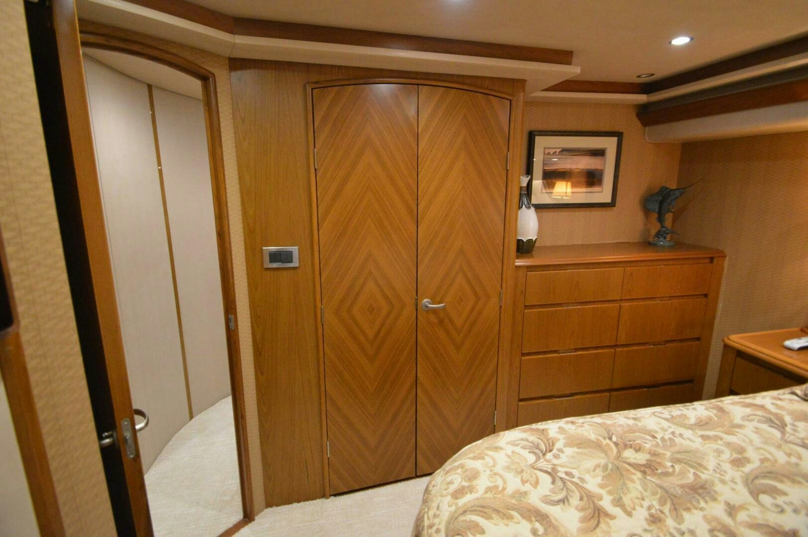 a bedroom with a closet and a bed aboard LOW PROFILE Yacht for Sale