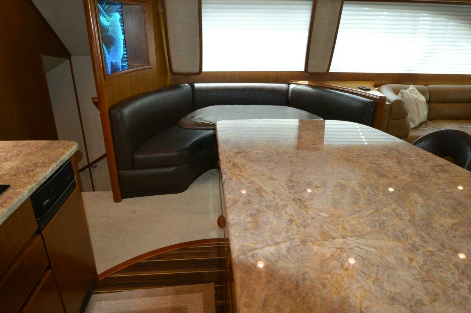 a couch and a table in a room aboard LOW PROFILE Yacht for Sale