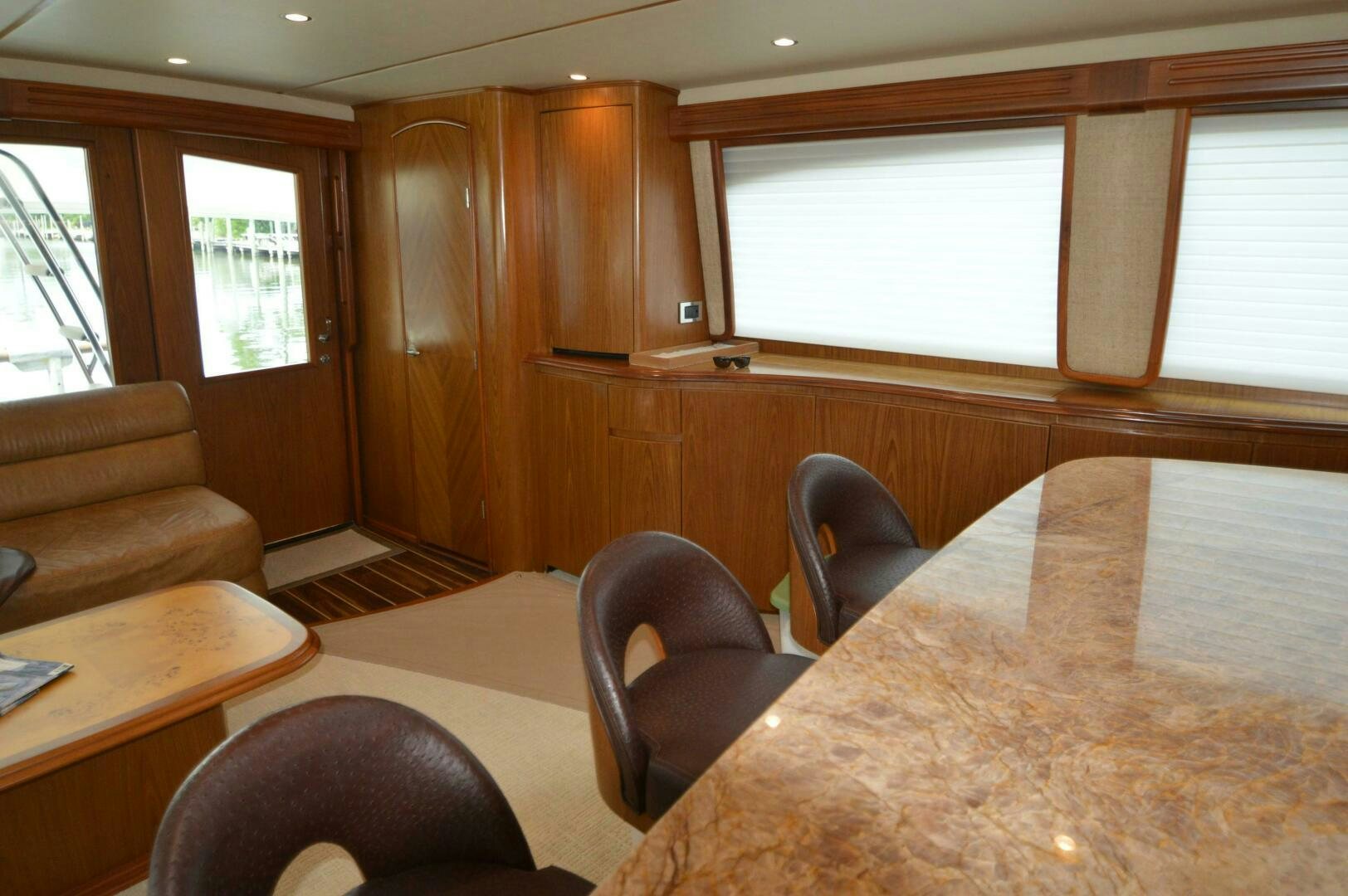 a room with a table and chairs aboard LOW PROFILE Yacht for Sale