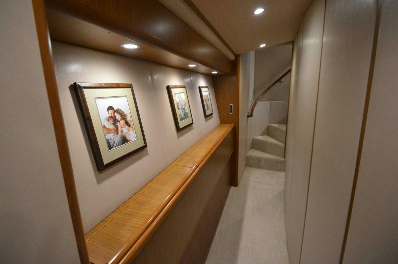 a hallway with a picture on the wall and a staircase aboard LOW PROFILE Yacht for Sale