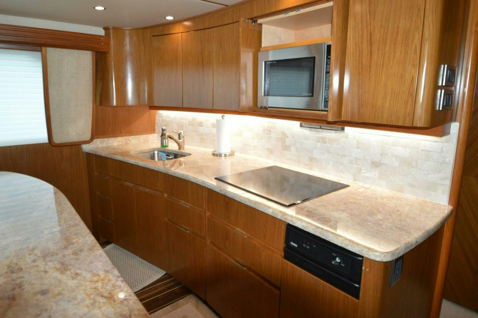a kitchen with wooden cabinets aboard LOW PROFILE Yacht for Sale