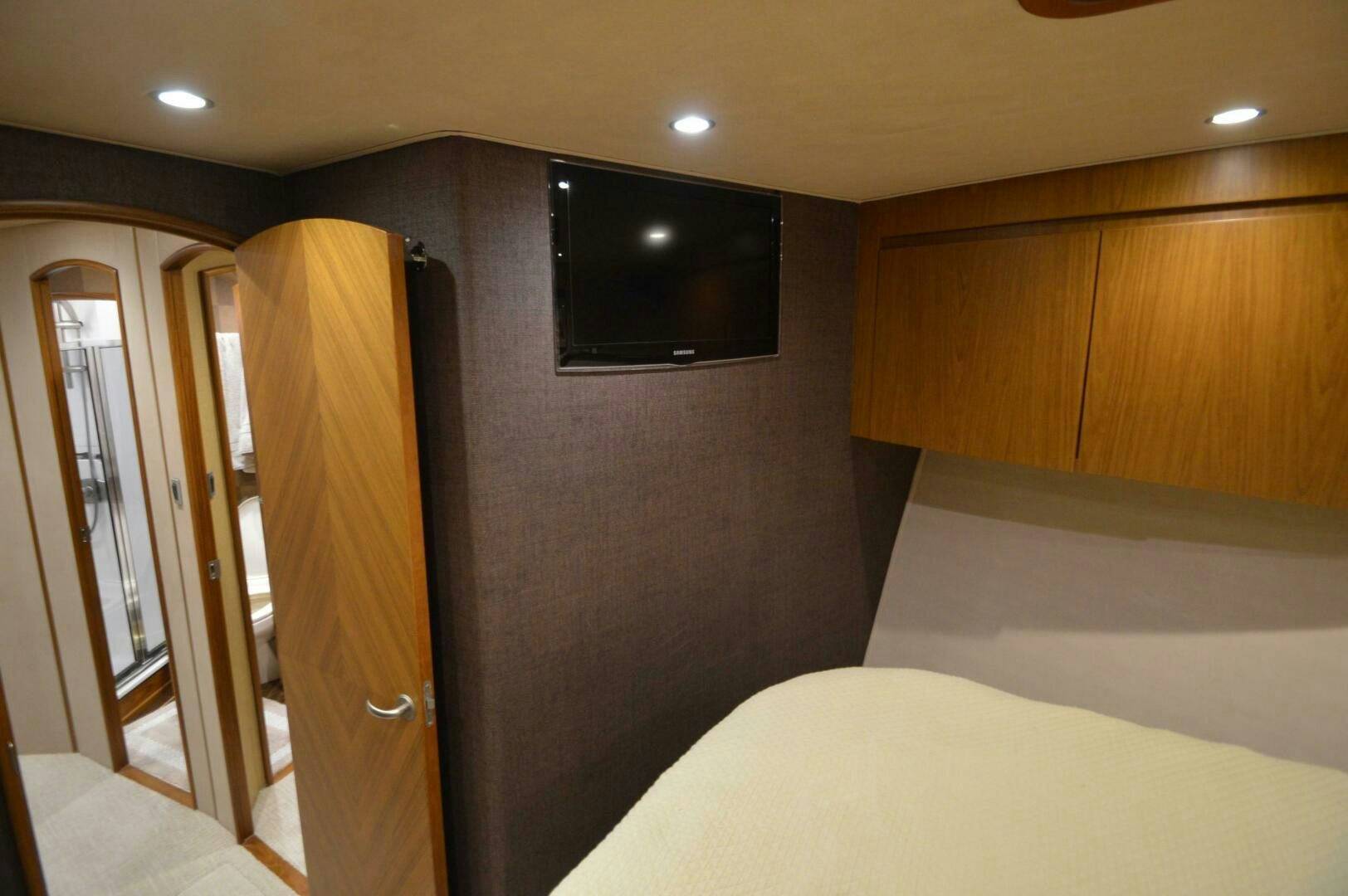 a hotel room with a tv and bed aboard LOW PROFILE Yacht for Sale