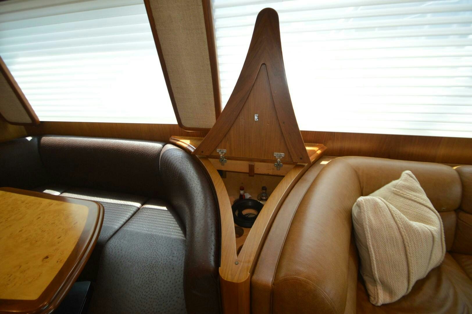 a room with a couch and a table with a lamp on it aboard LOW PROFILE Yacht for Sale