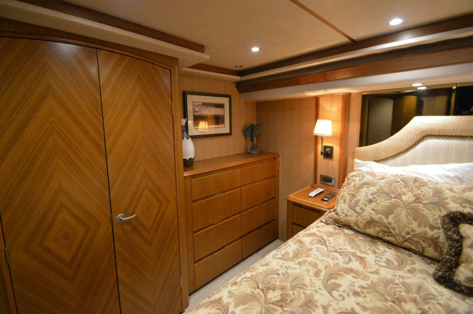 a bedroom with a bed and a closet aboard LOW PROFILE Yacht for Sale