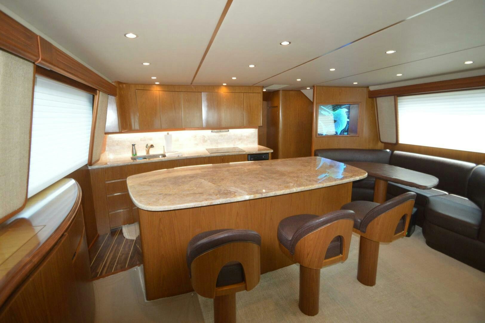 a kitchen with a bar and stools aboard LOW PROFILE Yacht for Sale