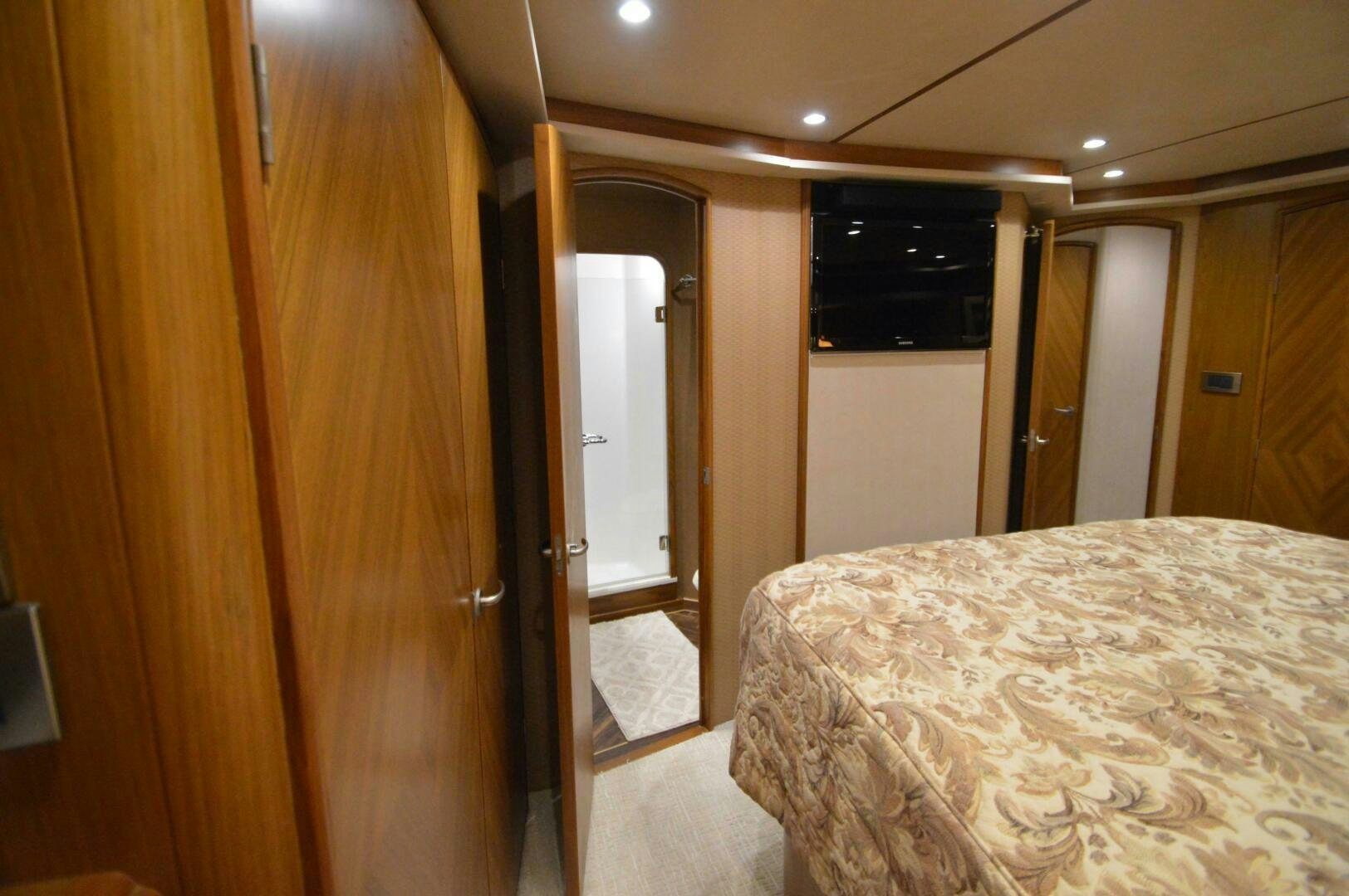 a bedroom with a bed and closet aboard LOW PROFILE Yacht for Sale