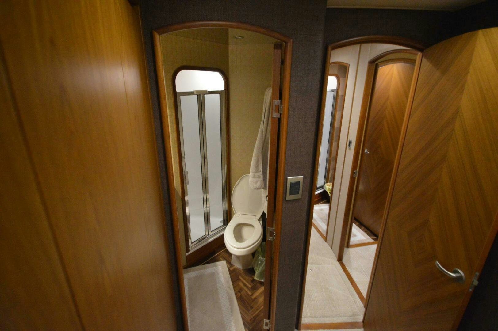a bathroom with a toilet and a mirror aboard LOW PROFILE Yacht for Sale