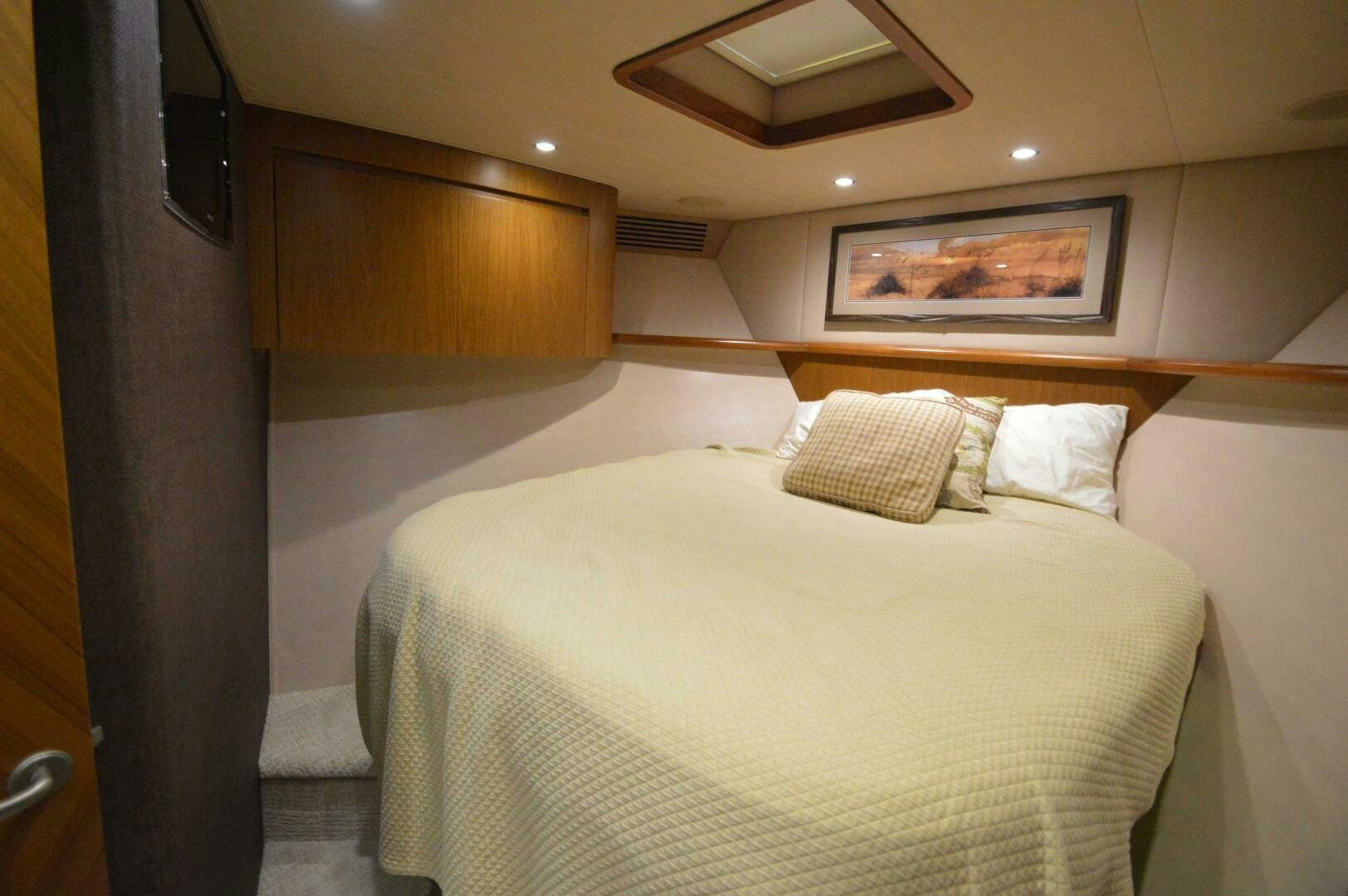 a room with a bed and a television aboard LOW PROFILE Yacht for Sale