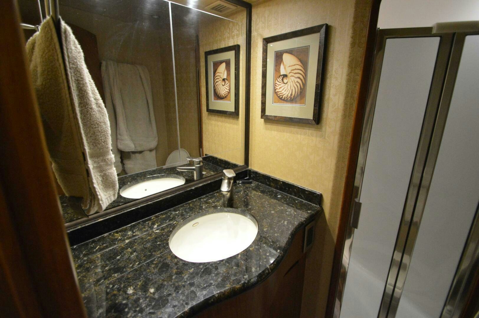 a bathroom with a sink and a mirror aboard LOW PROFILE Yacht for Sale