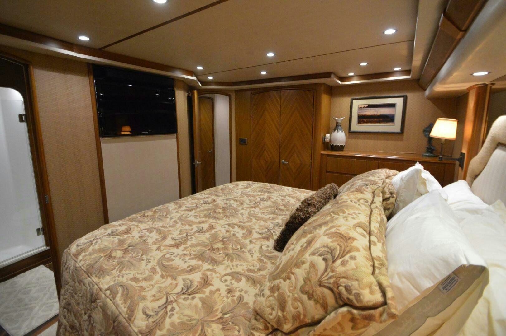 a bed with a white comforter aboard LOW PROFILE Yacht for Sale