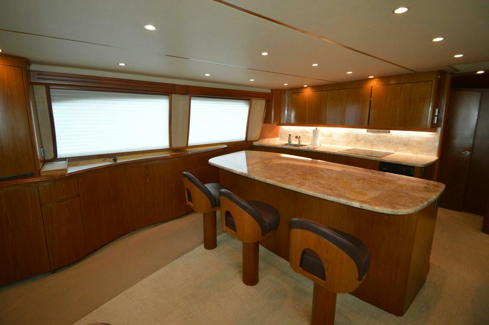 a kitchen with a bar and stools aboard LOW PROFILE Yacht for Sale