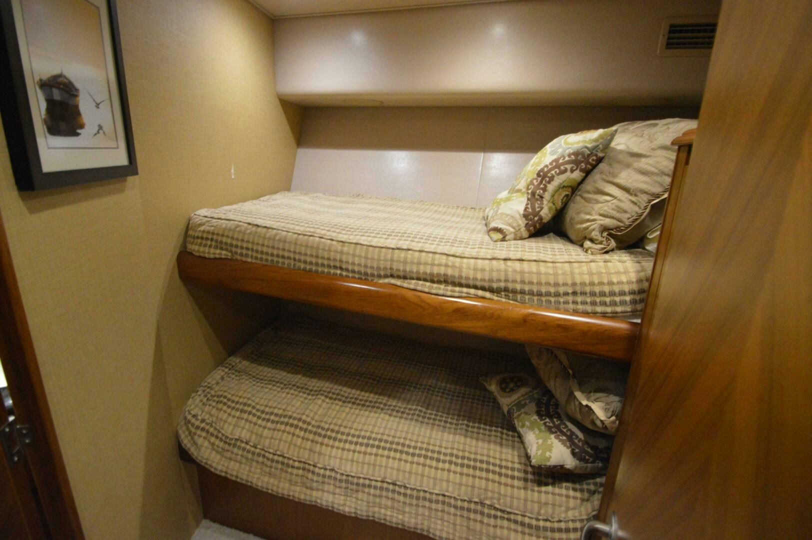 a bed with a wooden frame aboard LOW PROFILE Yacht for Sale