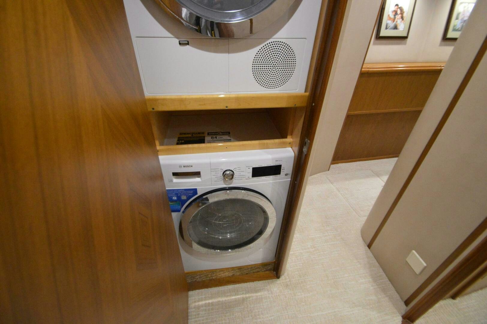 a washer and dryer in a wooden cabinet aboard LOW PROFILE Yacht for Sale