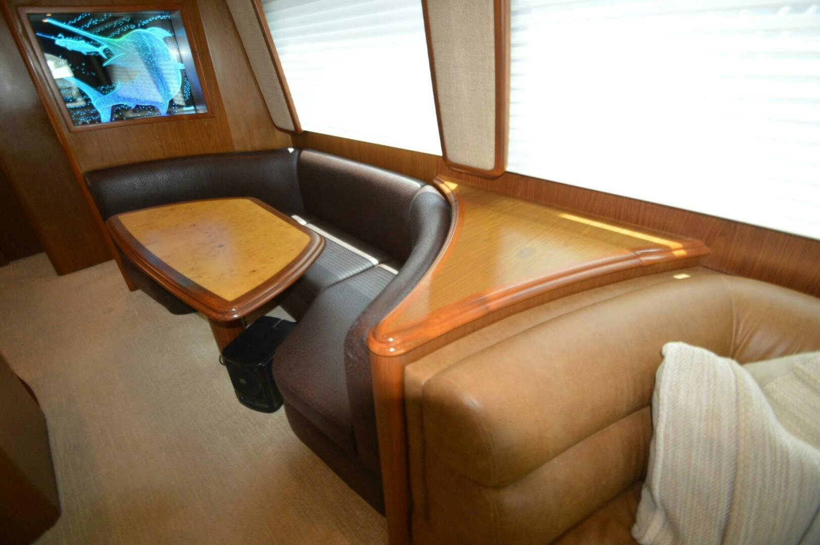 a couch and a table in a room aboard LOW PROFILE Yacht for Sale