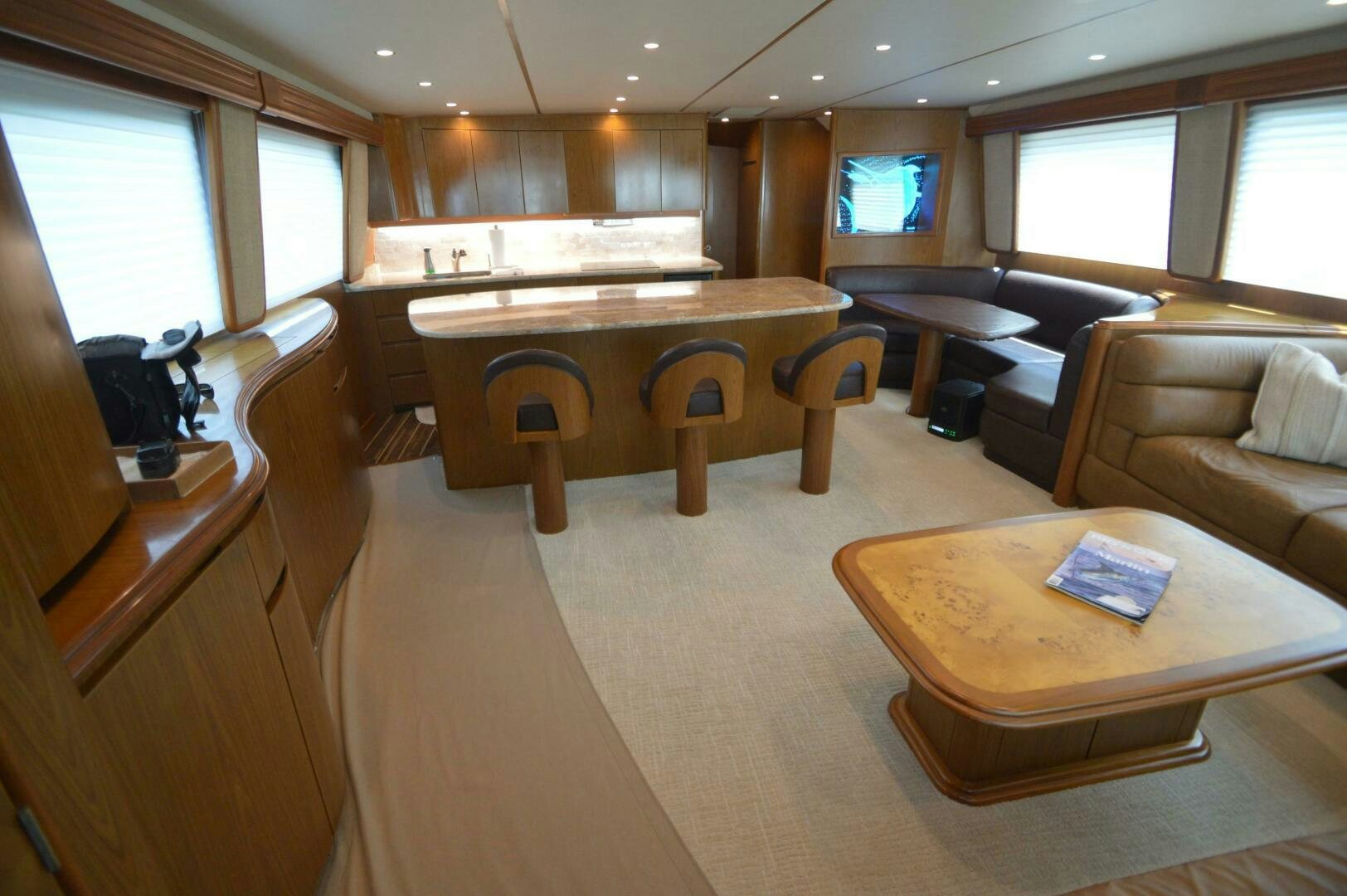 a room with a table and couches aboard LOW PROFILE Yacht for Sale