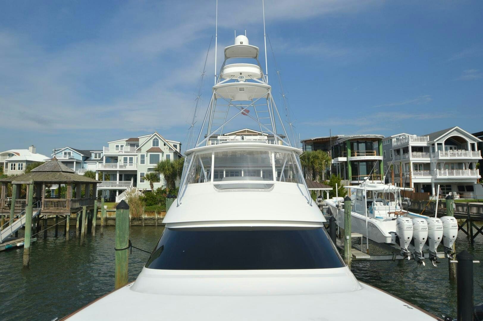 a large white boat in a harbor aboard LOW PROFILE Yacht for Sale