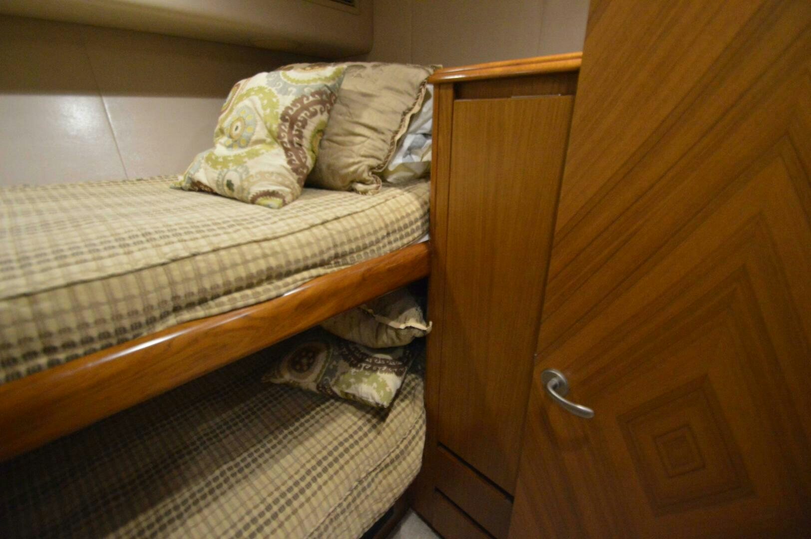 a bed with a blanket on it aboard LOW PROFILE Yacht for Sale