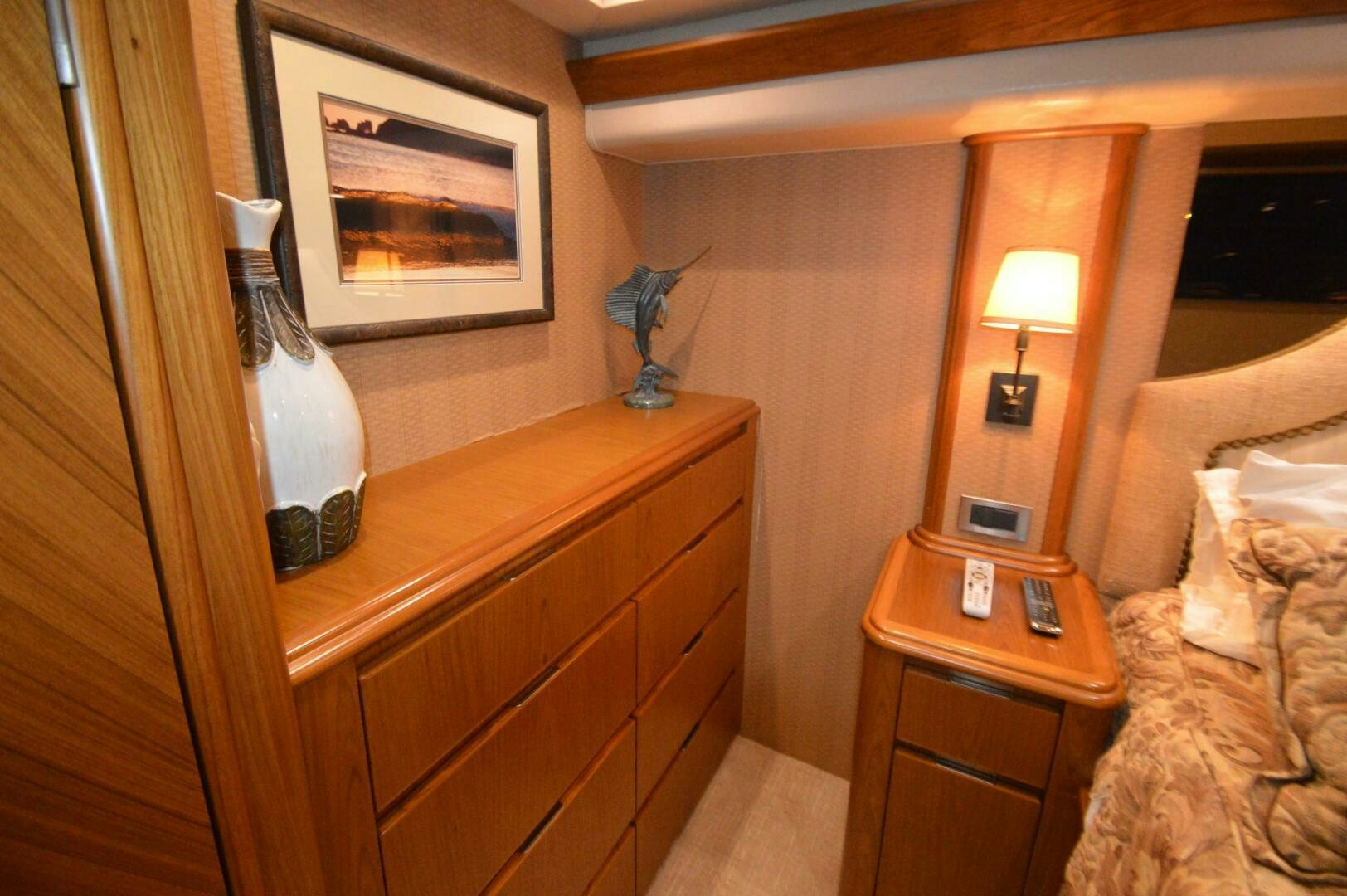a room with a bed and a dresser aboard LOW PROFILE Yacht for Sale