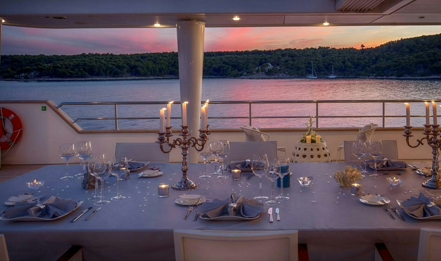 a table with candles and a cross on it aboard KATINA Yacht for Sale