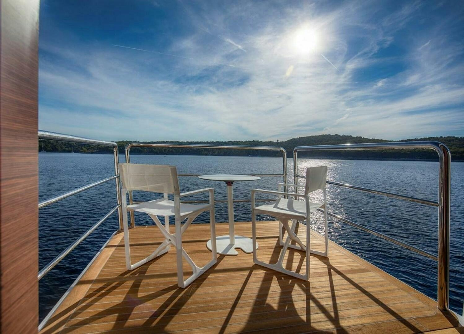 a deck with a table and chairs on it aboard KATINA Yacht for Sale