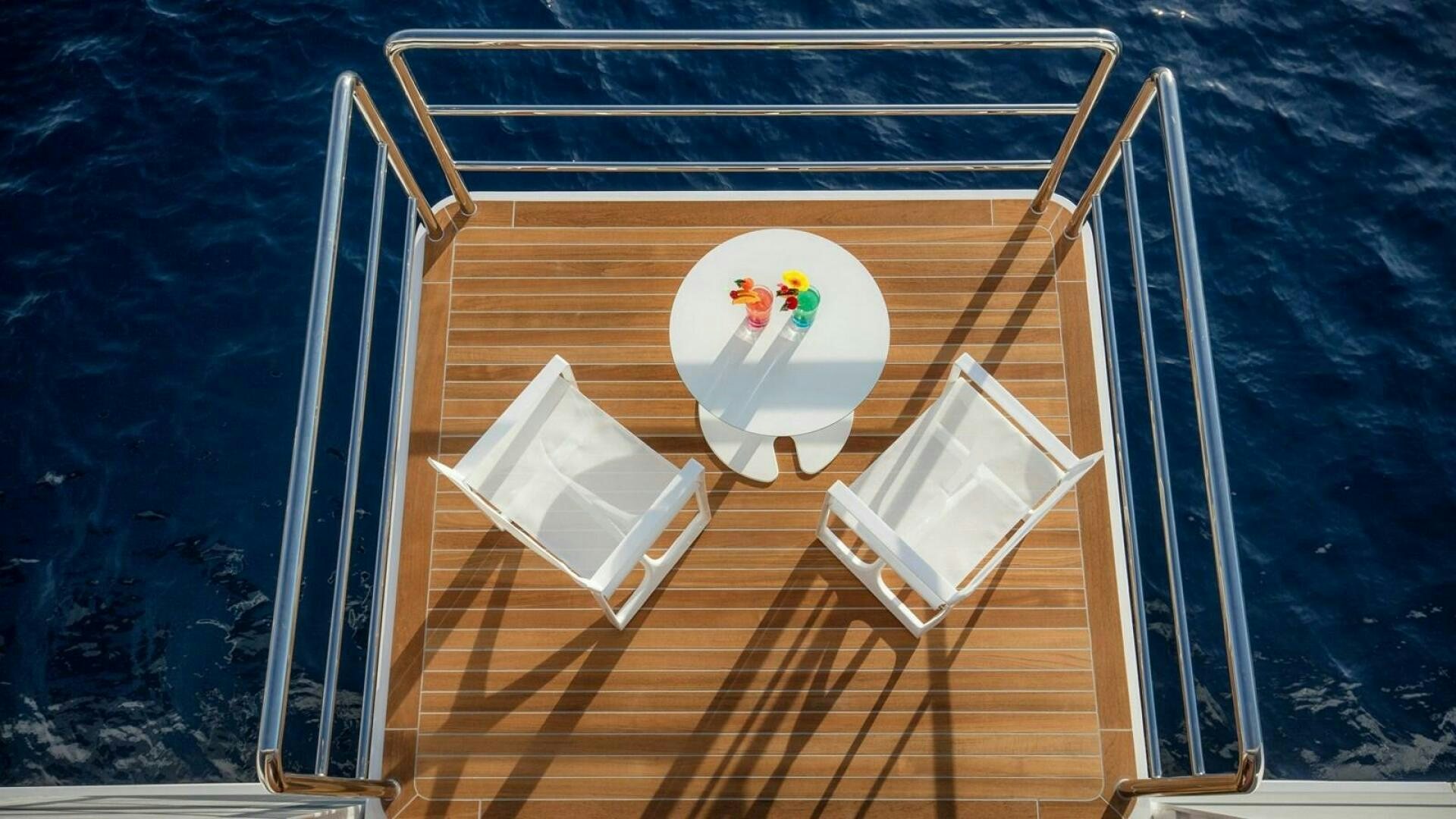 a small white boat with a wooden dock aboard KATINA Yacht for Sale