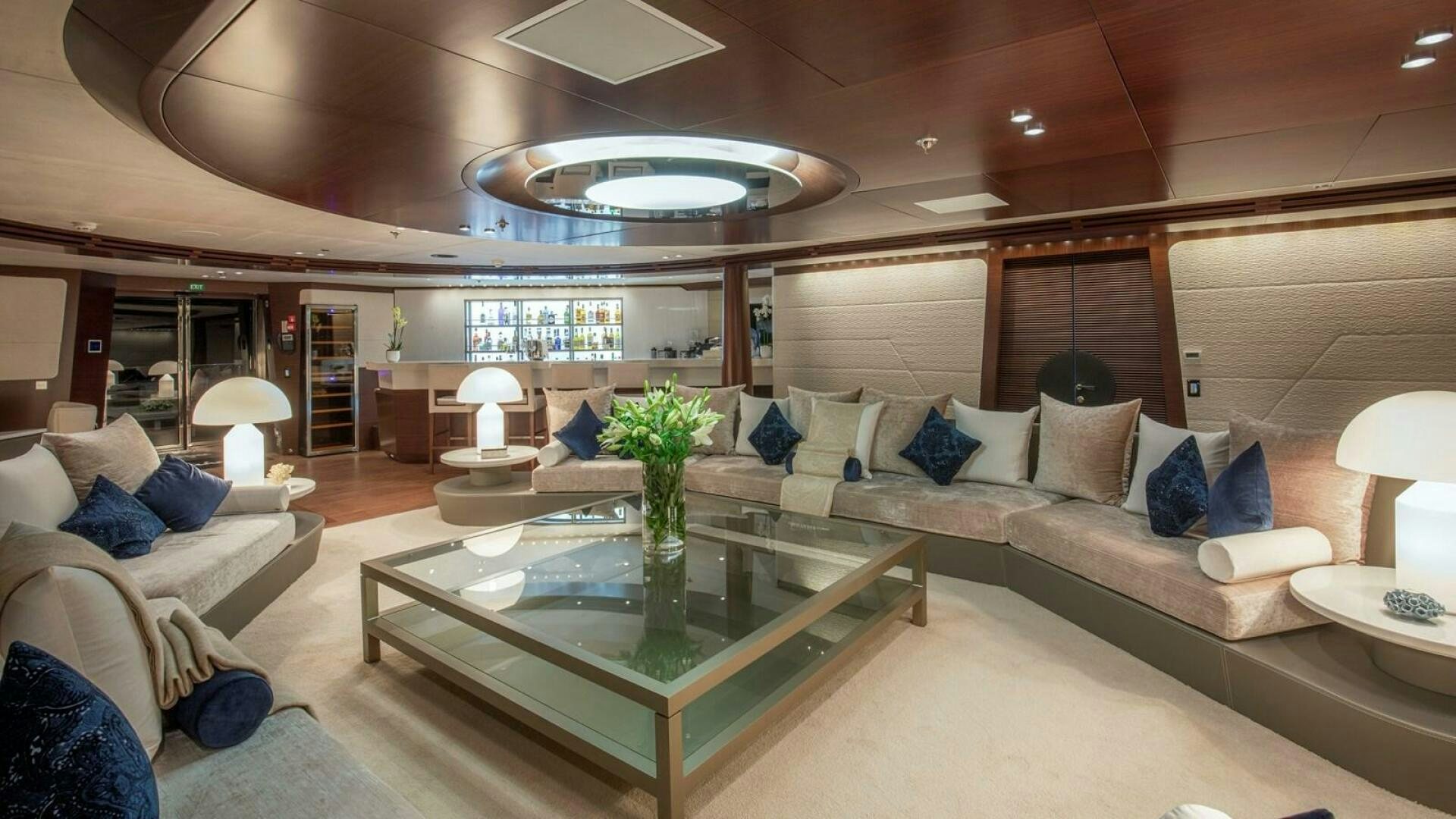 a living room with a large sofa and a coffee table aboard KATINA Yacht for Sale