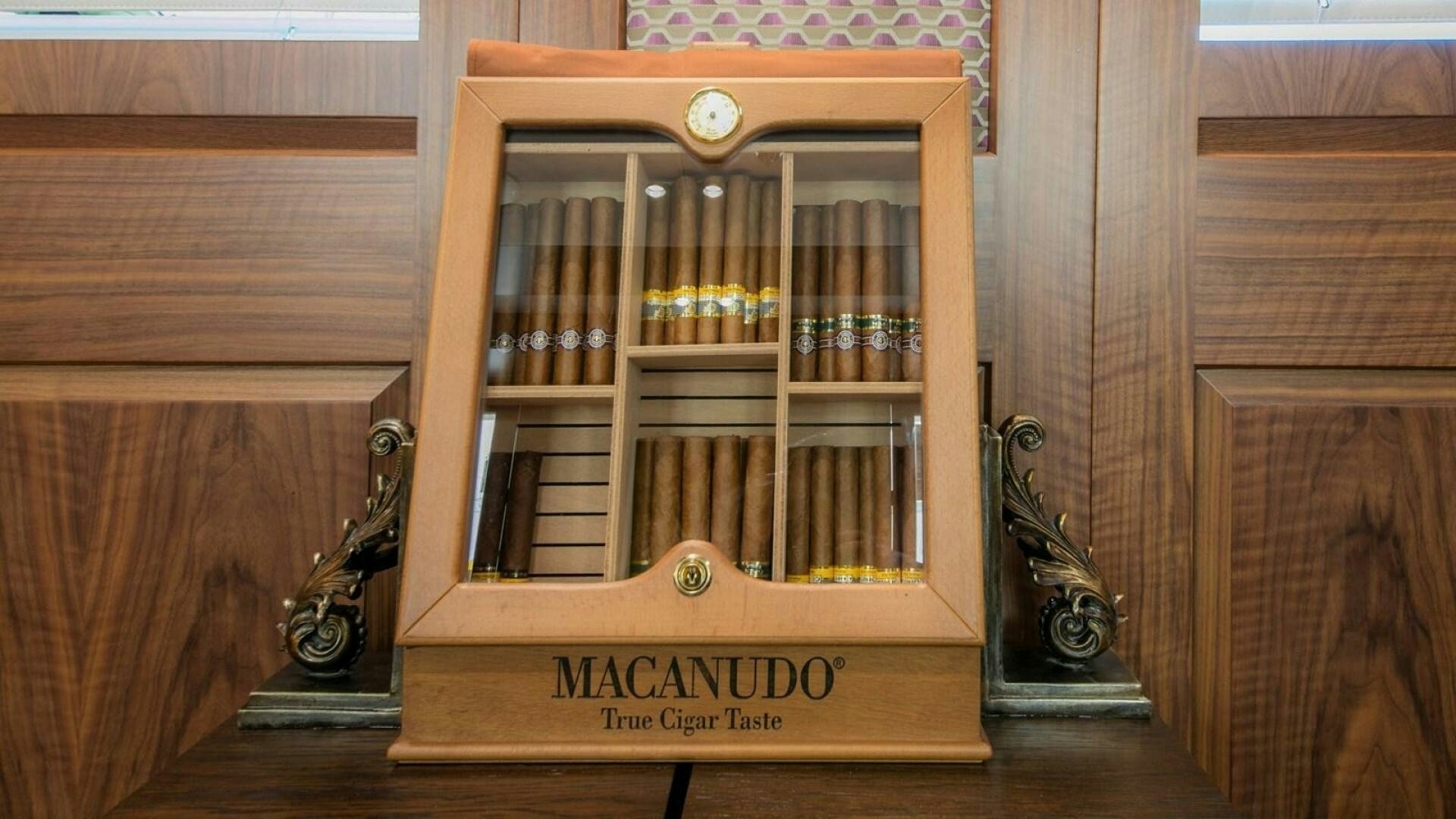 a book shelf with a guitar and a guitar aboard KATINA Yacht for Sale