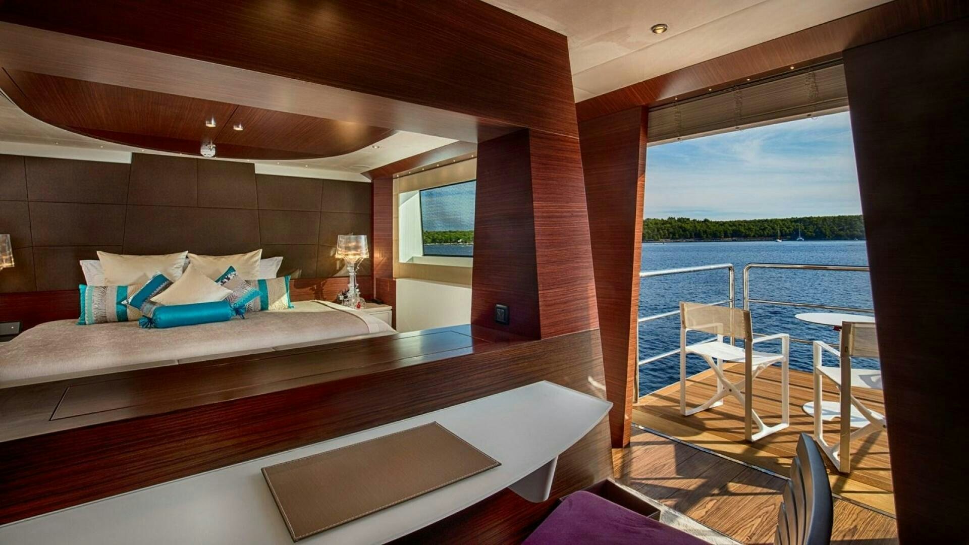 a bed with a table and chairs aboard KATINA Yacht for Sale