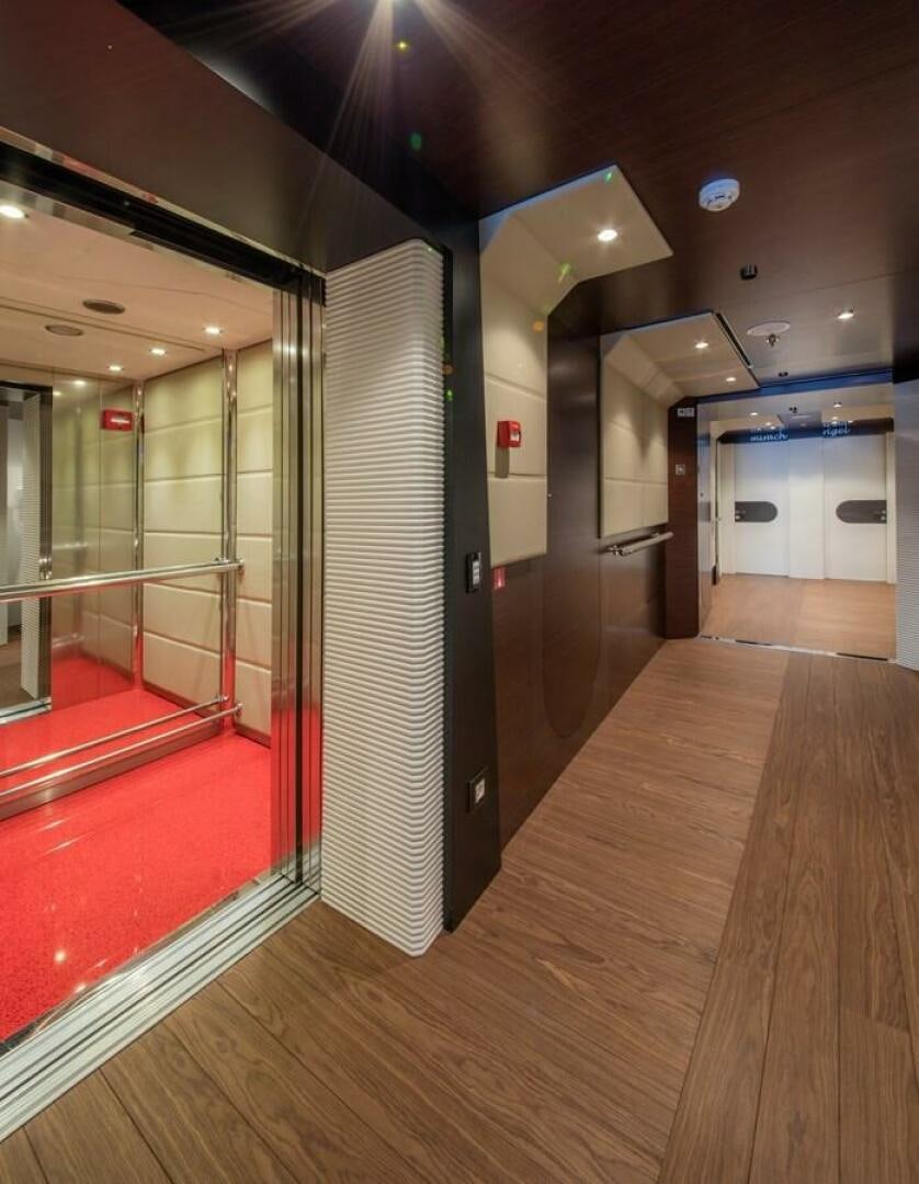 a long hallway with red railings aboard KATINA Yacht for Sale