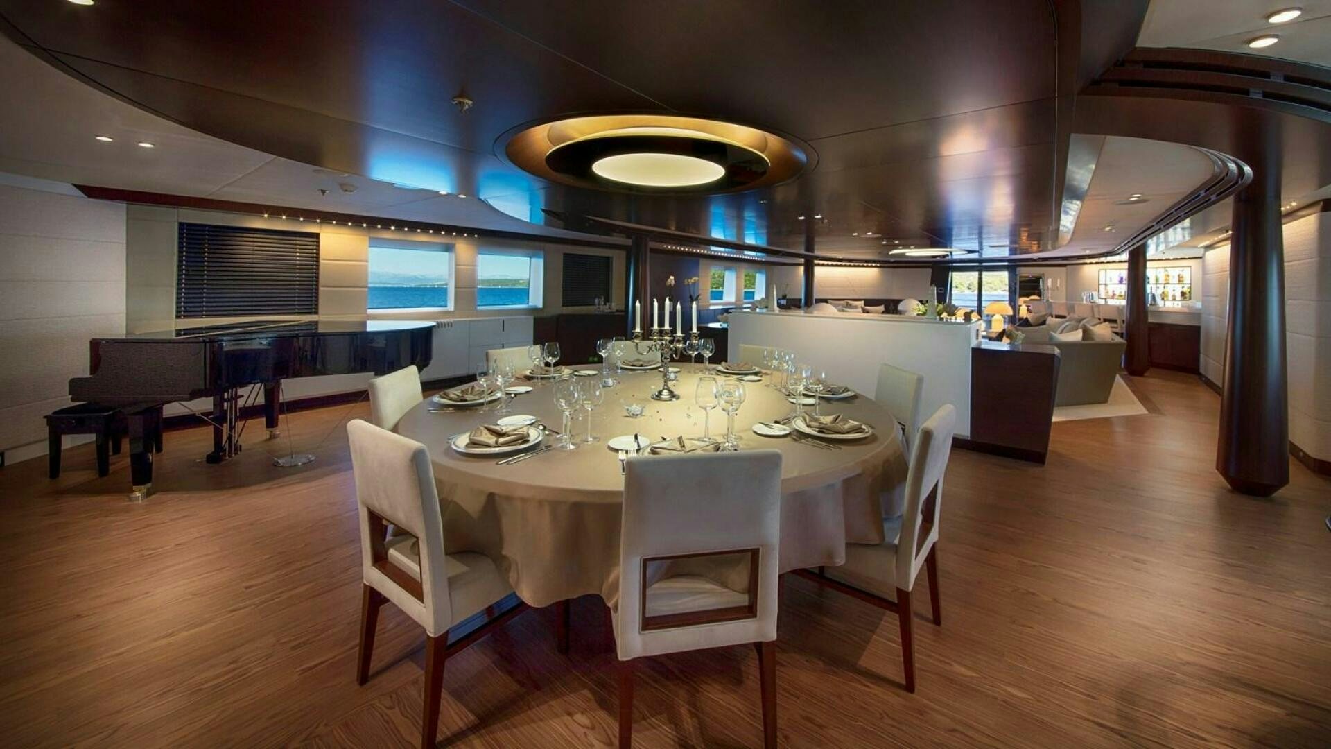 a large room with a table and chairs aboard KATINA Yacht for Sale