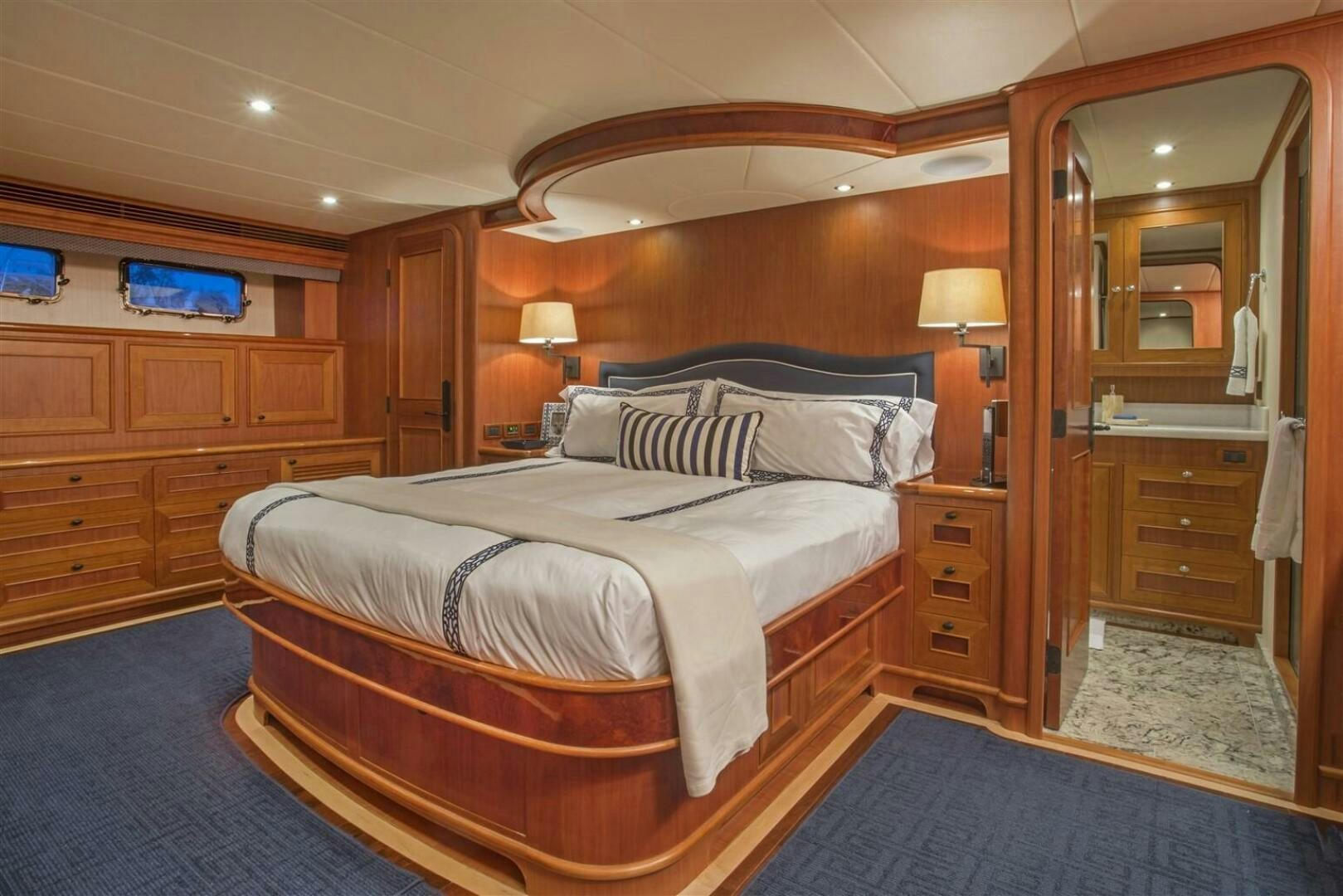 a bedroom with a bed and a closet aboard INSIGNIA Yacht for Sale